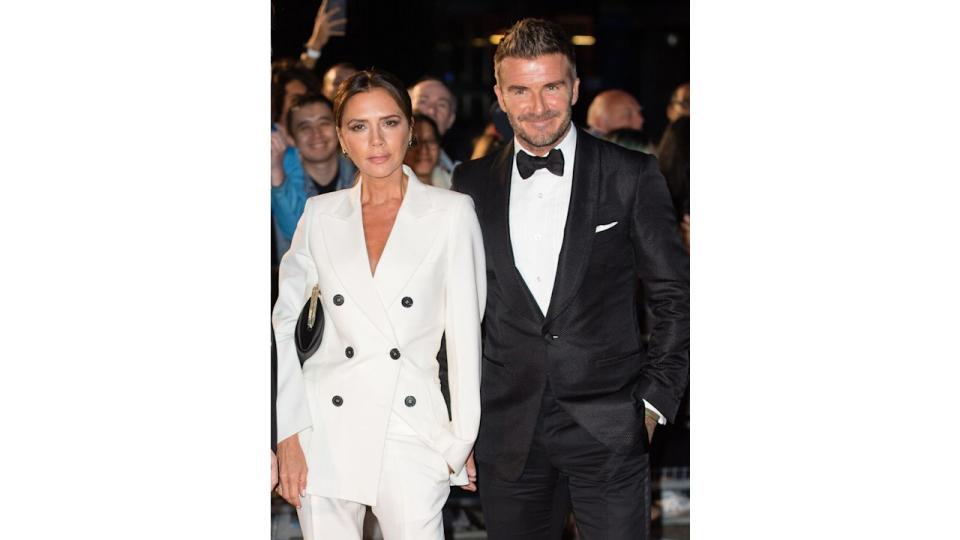 Victoria and David Beckham in a white suit and tuxedo