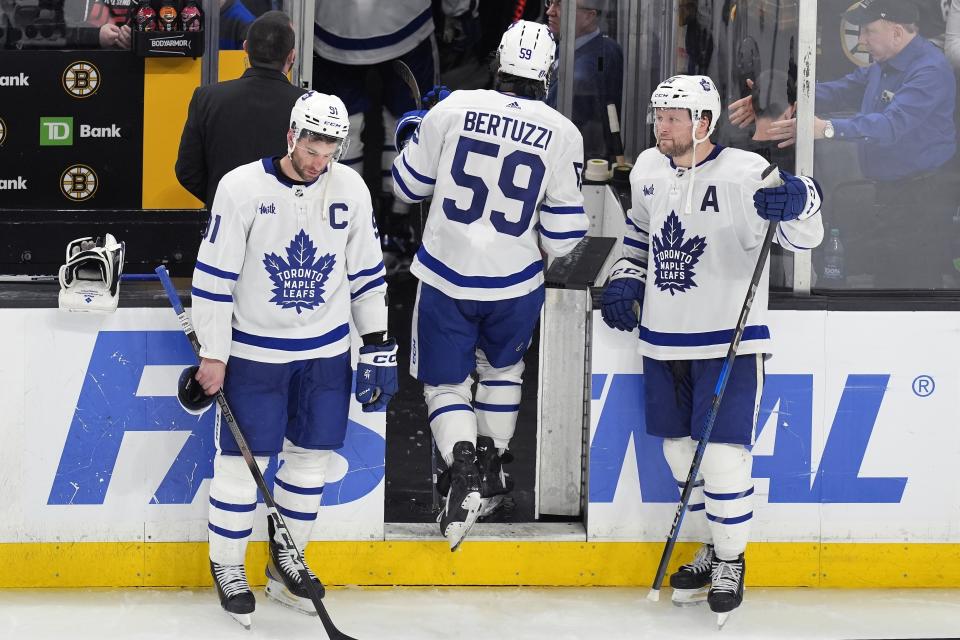 Toronto Maple Leafs' Tyler Bertuzzi (59) leaves the ice between John Tavares (91) and Morgan Rielly (44) after the team lost to the Boston Bruins in overtime during Game 7 of an NHL hockey Stanley Cup first-round playoff series, Saturday, May 4, 2024, in Boston. (AP Photo/Michael Dwyer)