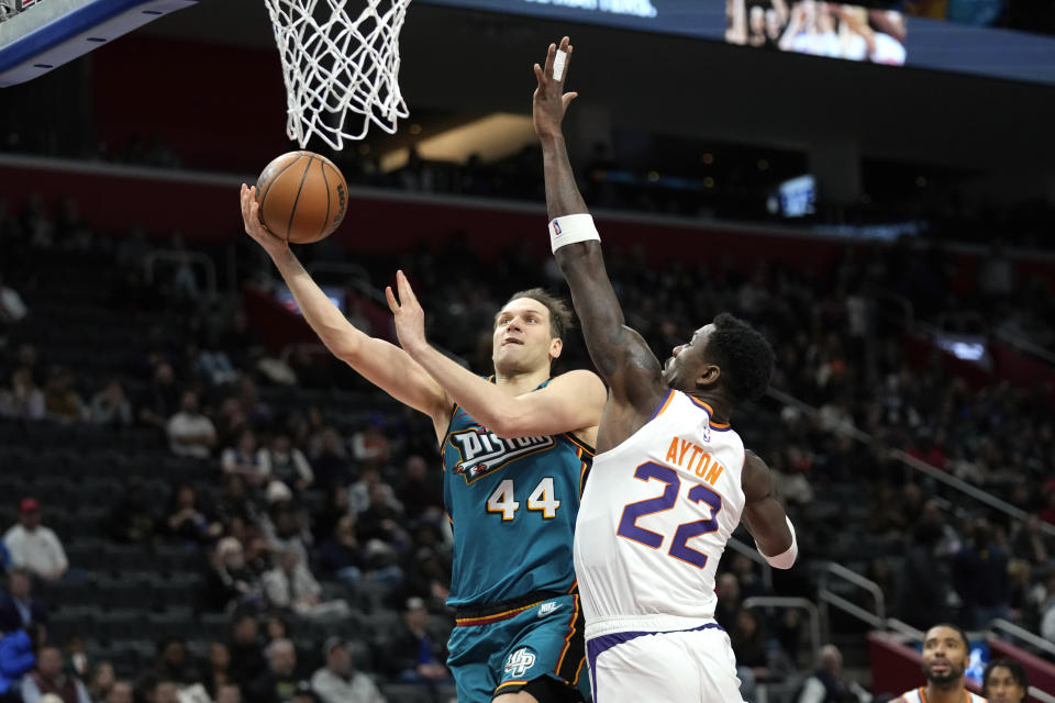 Detroit Pistons forward Bojan Bogdanovic (44) drives on Phoenix Suns center Deandre Ayton (22) in the second half of an NBA basketball game in Detroit, Saturday, Feb. 4, 2023. (AP Photo/Paul Sancya)