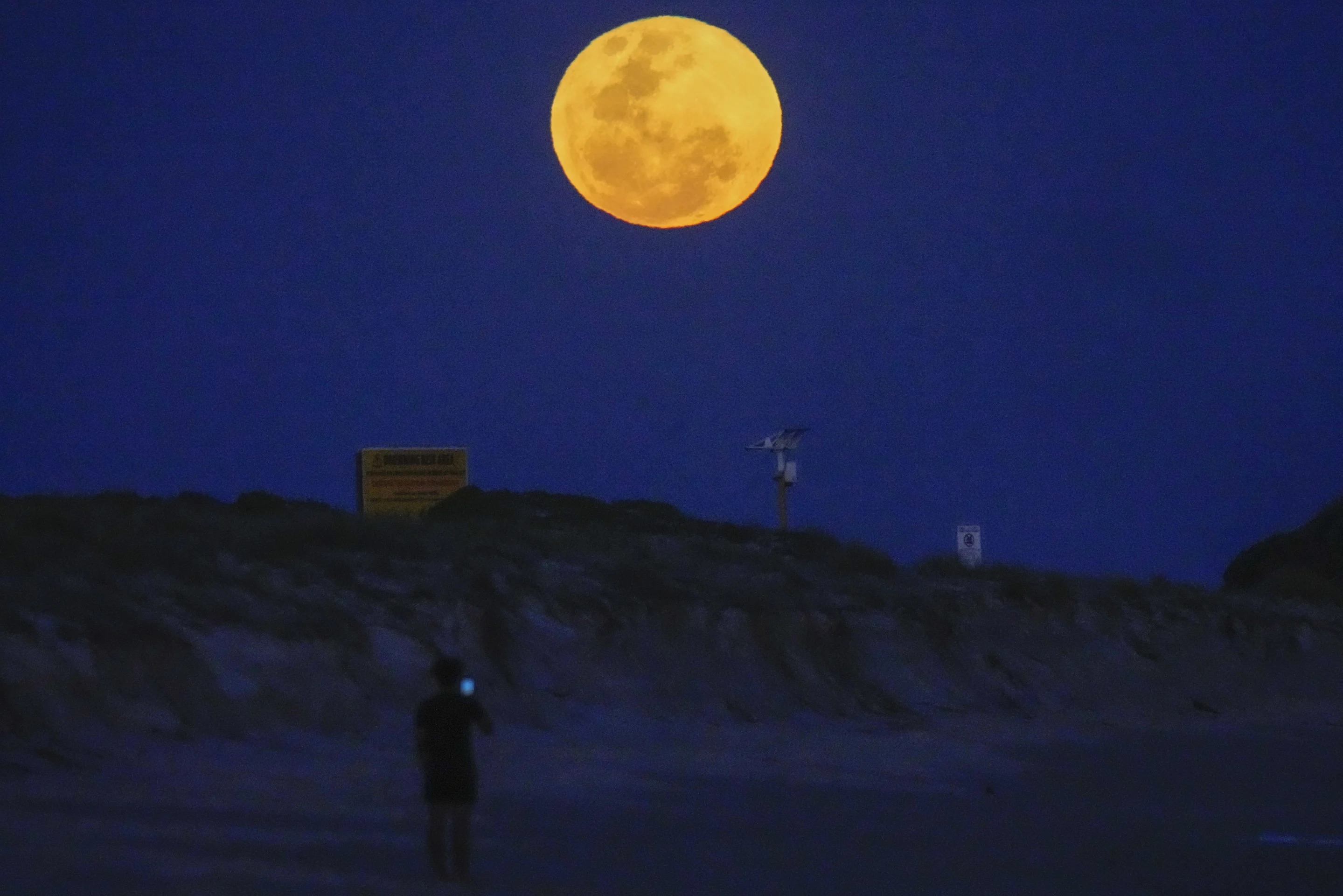 The moon rises over Fingal Bay in Port Stephens north of Sydney on Wednesday.