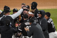 Chicago White Sox starting pitcher Carlos Rodon, center, celebrates his no hitter against the Cleveland Indians with his teammates in a baseball game, Wednesday, April, 14, 2021, in Chicago. (AP Photo/David Banks)