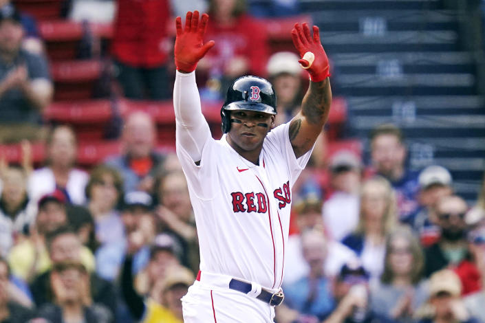 Boston Red Sox's Rafael Devers celebrates after his triple against the Houston Astros during the first inning of a baseball game at Fenway Park, Wednesday, May 18, 2022, in Boston. (AP Photo/Charles Krupa)