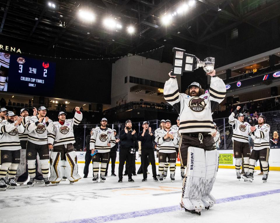 Hershey goaltender Hunter Shepard (30) raises up the Calder Cup trophy after Game 7 of the Calder Cup Finals at Acrisure Arena in Palm Desert, Calif., Wednesday, June 21, 2023. 