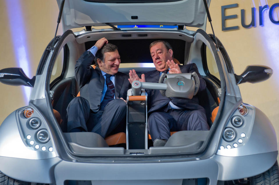 BRUSSELS, BELGIUM - JANUARY 24: EU Commission President Jose Manuel Barroso and Jesus Echave, chairman of the HIRIKO-AFYPAIDA corporate consortium, sit in the first prototype of the HIRIKO electric car, during the global launch of Hiriko Driving Mobility at the EU Commission headquarters on January 24, 2012 in Brussels, Belgium. The electronic, eco-friendly vehicle will be manufactured in deprived areas of cities who take up Hiriko's "social purpose" model. Malmo in Sweden has already signed up to trial Hiriko with Berlin, Barcelona, Vitoria-Gasteiz (the second largest Basque city), San Francisco, and Hong Kong expected to follow suit. (Photo by Geert Vanden Wijngaert/Getty Images)