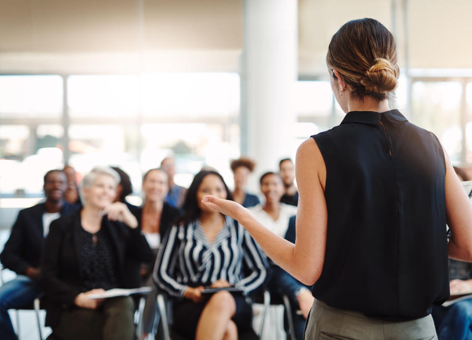 Shot of a young businesswoman delivering a speech during a conference.