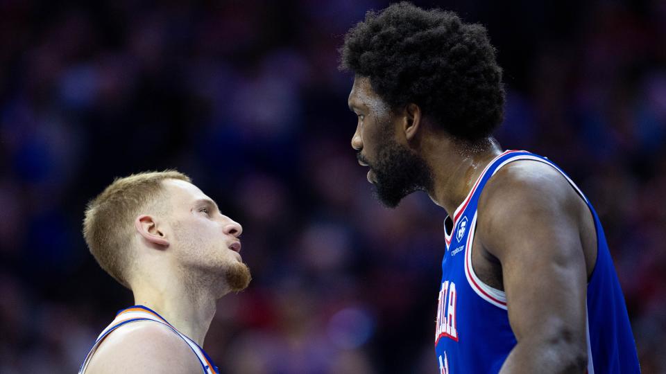 Apr 25, 2024; Philadelphia, Pennsylvania, USA; Philadelphia 76ers center Joel Embiid (21) has words with New York Knicks guard Donte DiVincenzo (L) after a play during the first quarter of game three of the first round for the 2024 NBA playoffs at Wells Fargo Center. Mandatory Credit: Bill Streicher-USA TODAY Sports