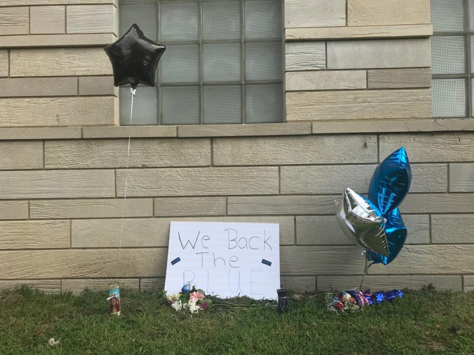 A small memorial in Terre Haute honors detective Greg Ferency, who was fatally shot July 7 at the FBI Indianapolis Resident Agency building.