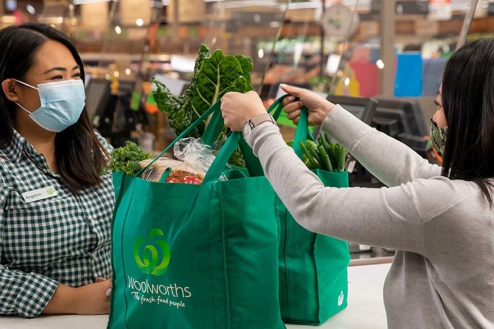 Woolworths staff member serves customer