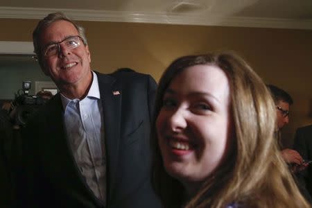 Former Florida Governor Jeb Bush (L) meets guests at a house party during a campaign stop in Dover, New Hampshire March 13, 2015. REUTERS/Shannon Stapleton