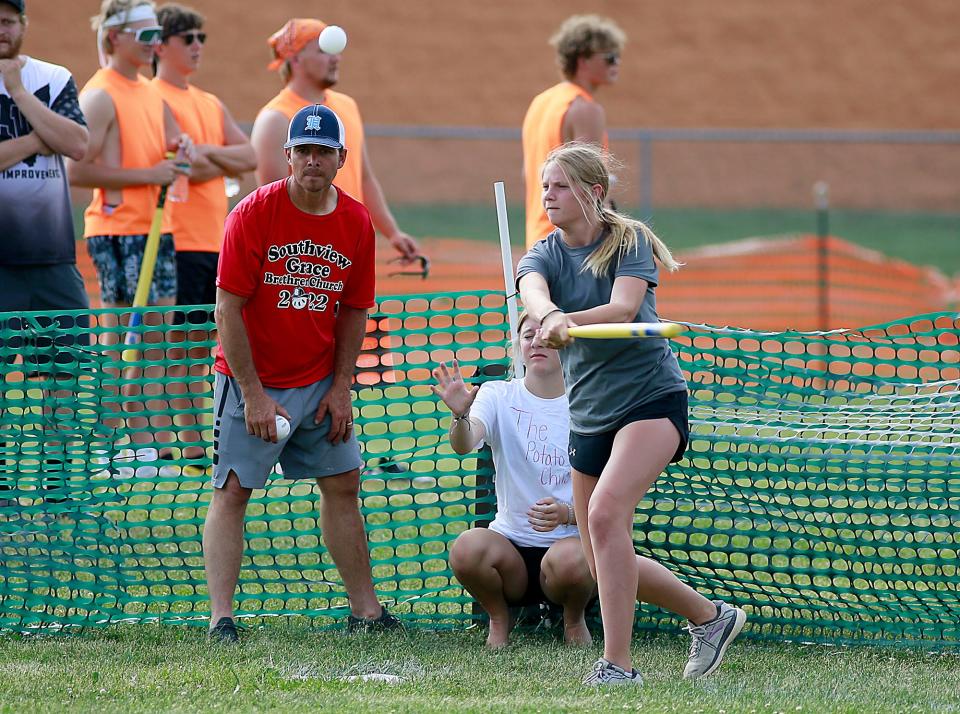 Heavy Hitters' Mya Donatini connects with a pitch as Savannah Bechler plays catcher for the Potato Chips during the Wifflefest high school tournament Friday, July 1, 2022 at Southview Grace Brethren Church. TOM E. PUSKAR/ASHLAND TIMES-GAZETTE