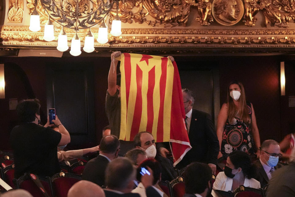 A man holds an "estelada" or Catalan pro-independence flag during a speech of Spain's prime minister Pedro Sanchez, not pictured, at the Gran Teatre del Liceu in Barcelona, Spain, Sunday, June 21, 2021. Sanchez's said Monday that the Spanish Cabinet will approve pardons for nine separatist Catalan politicians and activists imprisoned for their roles in the 2017 push to break away from Spain. (AP Photo/Emilio Morenatti)