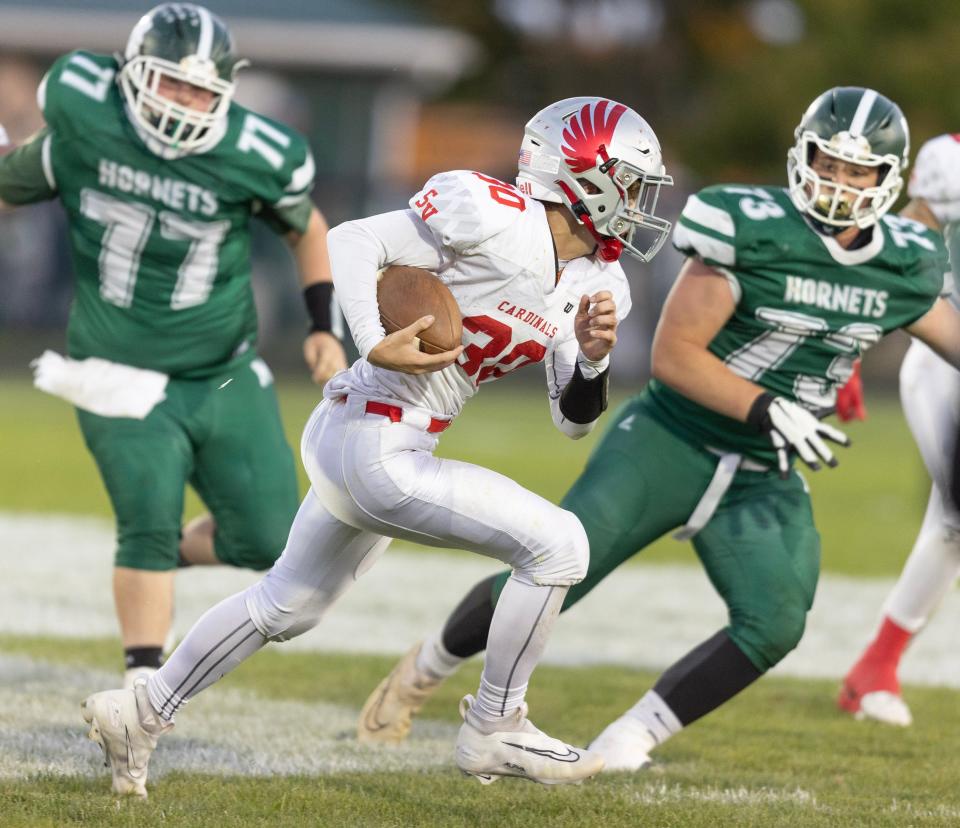 Sandy Valley running back Jack Murphy runs for a gain as Malvern defenders Conner Chalmers, 77, and Kyle Bossert, 73, close in, Friday, Sept. 15, 2023.