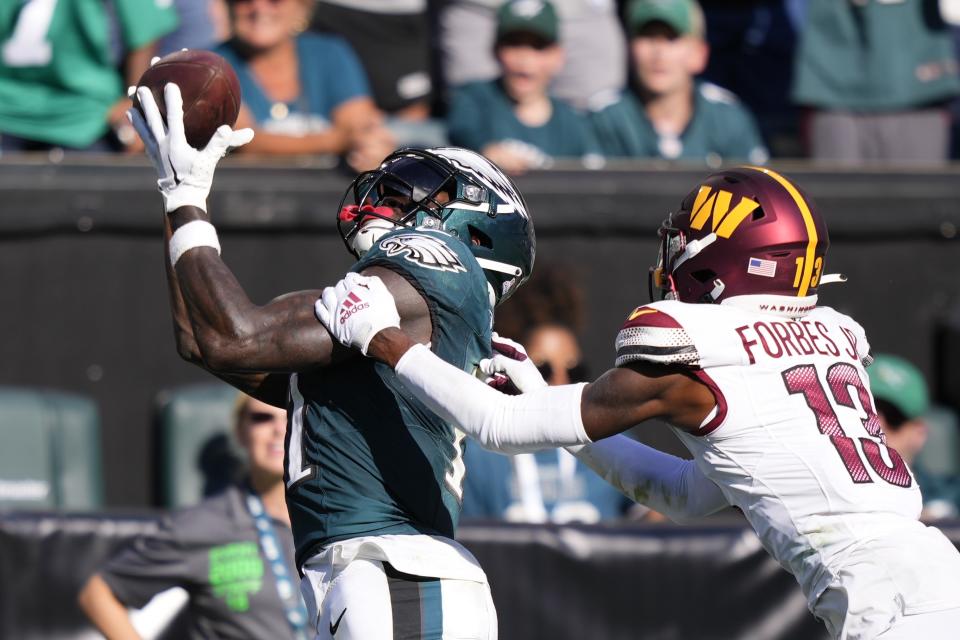 Philadelphia Eagles wide receiver A.J. Brown (11) makes a touchdown catch in front of Washington Commanders cornerback Emmanuel Forbes (13) during the second half of an NFL football game Sunday, Oct. 1, 2023, in Philadelphia. (AP Photo/Matt Slocum)