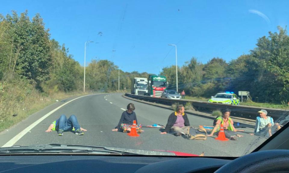 Protesters appear to have glued their hands to the road in Dover.