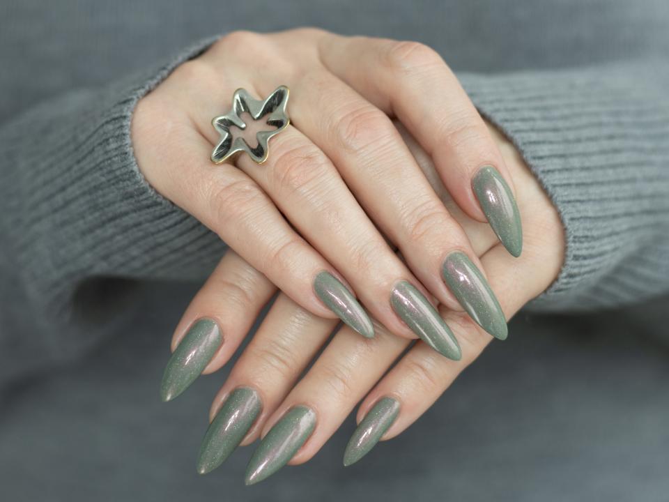 Shiny, sage green nails.