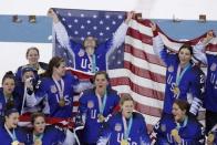 Ice Hockey - Pyeongchang 2018 Winter Olympics - Women's Gold Medal Final Match - Canada v USA - Gangneung Hockey Centre, Gangneung, South Korea - February 22, 2018 - Team USA players hold up their gold medals and a U.S. flag as they celebrate after winning their game. REUTERS/Brian Snyder