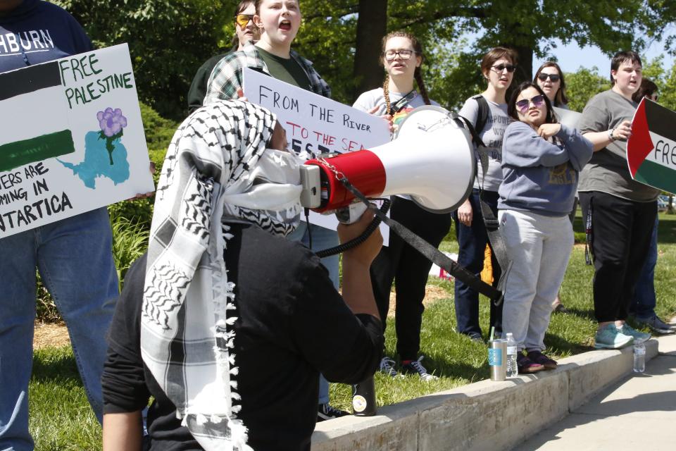 Sierra Jeter, a senior at Washburn University, leads chants Friday during a protest of the Israeli-Hamas War on the campus of Washburn University.