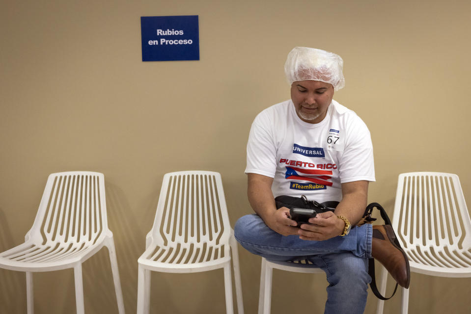 A fan of the Puerto Rico baseball team gets his hair bleached as part of a mass hair dying event in an attempt to break the Guinness World Record for the most hair dyed in eight hours in Guaynabo, Puerto Rico, Friday, March 10, 2023. Going blond, which began as a joke among team members playing in California many years ago, was set up by fans to show support for their team competing at the World Baseball Classic. (AP Photo/Alejandro Granadillo)