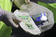 Officers from the Ministry of Environment show samples of plastics waste shipment from Australia in Port Klang, Malaysia, Tuesday, May 28, 2019. Malaysia says it will send back some 3,000 metric tonnes (330 tons) of non-recyclable plastic waste to countries including the U.S., U.K., Canada and Australia in a move to avoid becoming a dumping ground for rich nations. (AP Photo / Vincent Thian)