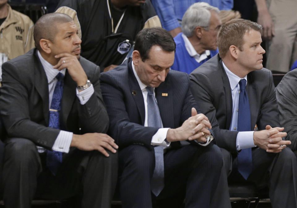 Duke coach Mike Krzyzewski, center, and assistant coaches Jeff Capel, left, and Steve Wojciechowski, right, watch the final minute of an NCAA college basketball game against Wake Forest in Winston-Salem, N.C., Wednesday, March 5, 2014. Wake Forest won 82-72. (AP Photo/Chuck Burton)