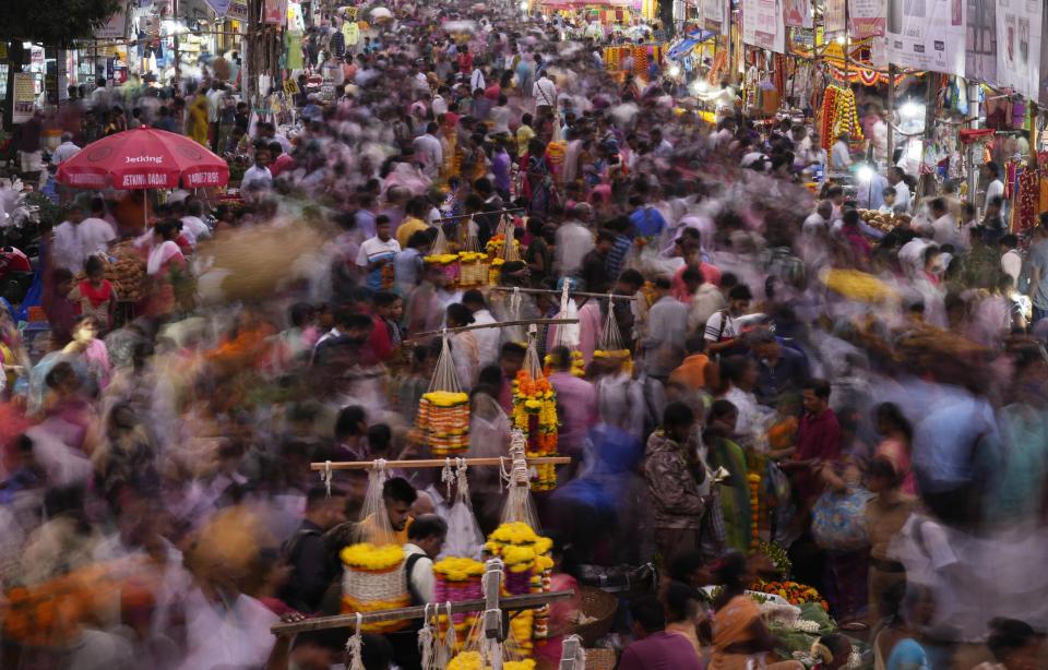 FILE - People crowd a market on the eve of of Dussehra festival in Mumbai, India, Oct. 4, 2022. Demographers are unsure exactly when India will take the title as the most populous nation in the world because they're relying on estimates to make their best guess. (AP Photo/Rajanish Kakade, File)