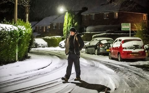 A man walks in snowy conditions in Oxspring, near Barnsley - Credit: Danny Lawson /PA