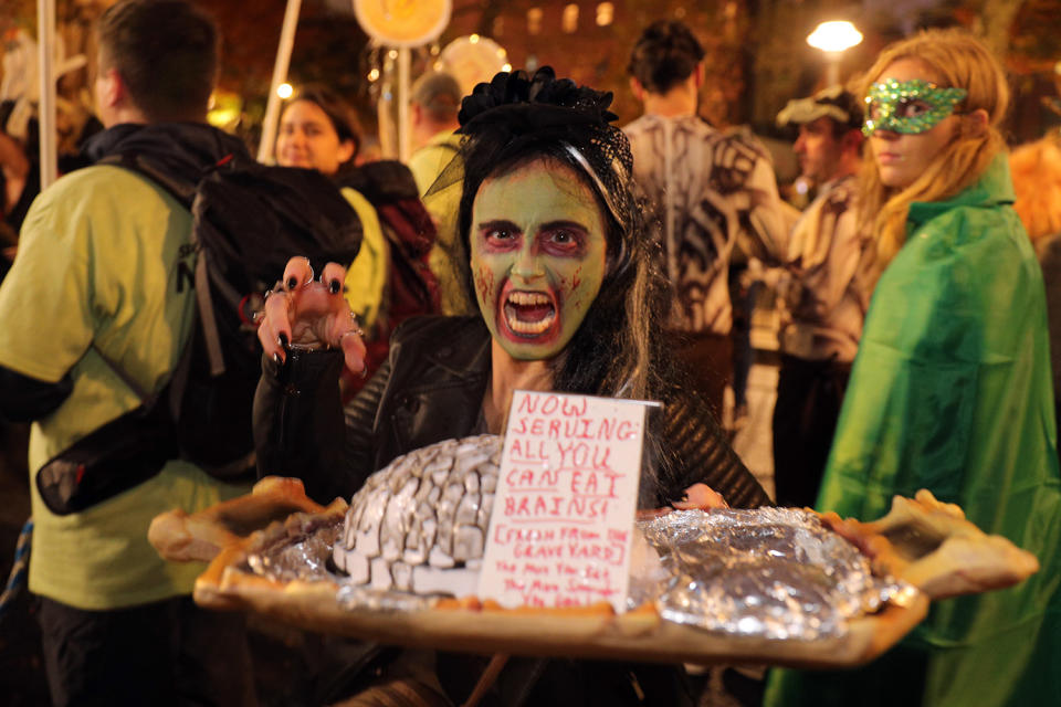 A woman in costume offers a tray of brains during Halloween Parade in New York City. (Photo: Gordon Donovan/Yahoo News)