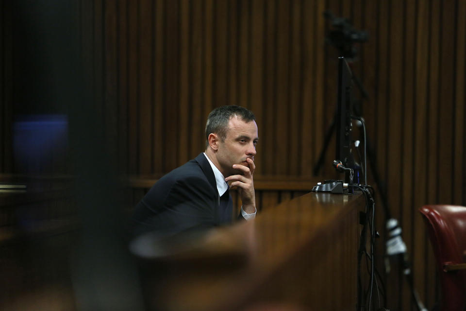Oscar Pistorius listens to evidence being given in court in Pretoria, South Africa, Tuesday, April 15, 2014 after questioning by state prosecutor Gerrie Nel, had earlier finished. Pistorius is charged with the murder of his girlfriend Reeva Steenkamp, on Valentines Day in 2013. (AP Photo/Alon Skuy, Pool)