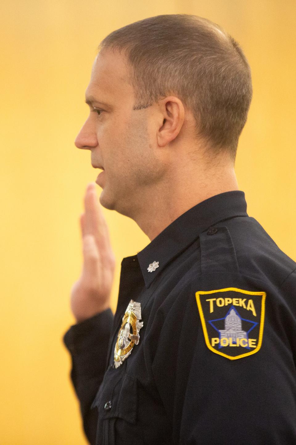 Topeka Deputy Police Chief Jamey Haltom takes an oath during Tuesday's trial.