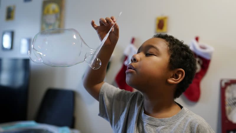 Elijah Hill plays with his bubbles on Saturday, Dec. 9, 2023, in Westfield, Ind.