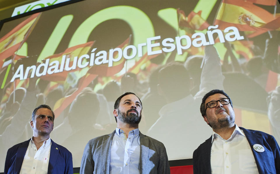 In this Sunday, Dec. 2, 2018 photo, Spain's far-right Vox Party President Santiago Abascal, centre, with the general secretary, Javier Ortega, left, and regional candidate Francisco Serrano take part in a rally during regional elections in Andalusia, in Seville, Spain. The Socialists won just 33 seats in the Andalusia legislature, compared to 47 in 2015. The party could lose control of Spain's most populated region for the first time in 36 years if parties on the right can agree to form a government. The anti-immigrant, extreme right Vox party won 12 seats - its first in any Spanish legislative body. (AP Photo/Gogo Lobato)