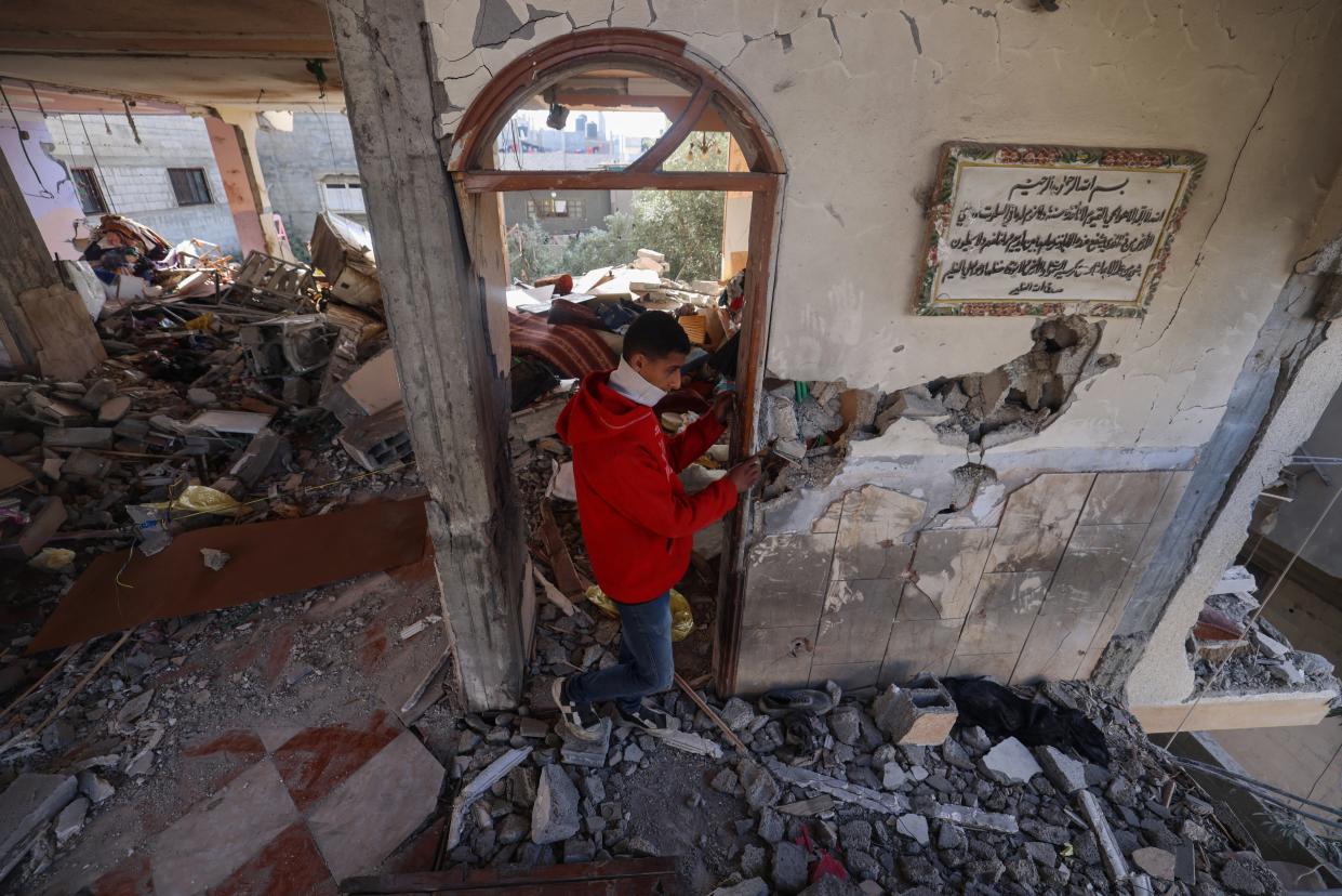 A Palestinian youth inspects a damaged apartment following overnight Israeli bombardment in Rafah in the southern Gaza Strip on April 4, 2024.