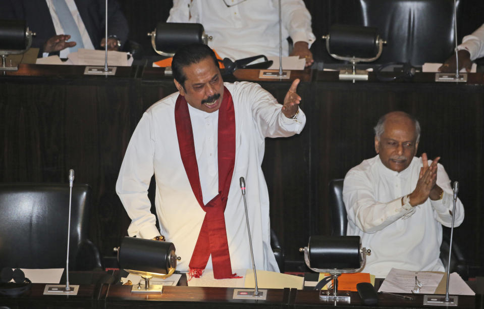 Sri Lankan disputed Prime Minister Mahinda Rajapaksa speaks at the parliament chamber in Colombo, Sri Lanka, Thursday, Nov. 15, 2018. Rival lawmakers exchanged blows in Sri Lanka's Parliament on Thursday as disputed Prime Minister Mahinda Rajapaksa claimed the speaker had no authority to remove him from office by voice vote. (AP Photo/Lahiru Harshana)