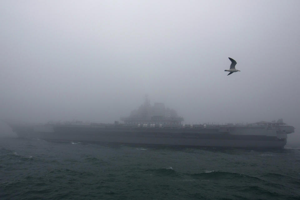 FILE - In this April 23, 2019, file photo, the Chinese People's Liberation Army (PLA) Navy aircraft carrier Liaoning participates in a naval parade to commemorate the 70th anniversary of the founding of China's PLA Navy in the sea near Qingdao in eastern China's Shandong province. China says it is holding naval drills involving the battlegroup of the aircraft carrier Liaoning in waters near Taiwan. (AP Photo/Mark Schiefelbein, Pool, File)