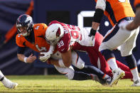 Arizona Cardinals defensive end J.J. Watt (99) sacks Denver Broncos quarterback Brett Rypien (4) during the first half of an NFL football game, Sunday, Dec. 18, 2022, in Denver. (AP Photo/Jack Dempsey)