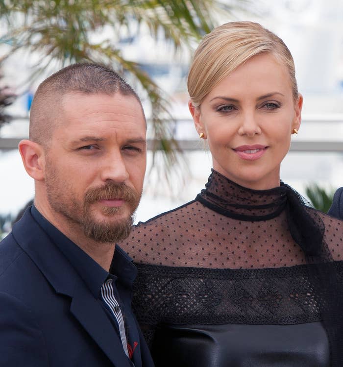 Tom Hardy and Charlize Theron pose together at a media event