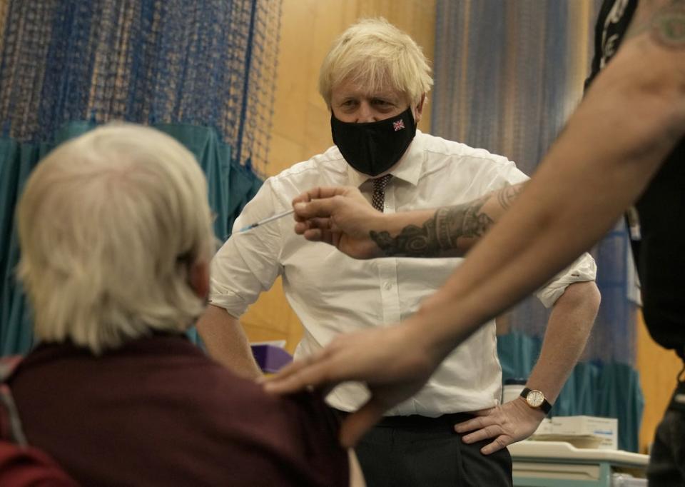 Prime Minister Boris Johnson watches as Nitza Sarner, 88, receives a Pfizer booster vaccination at the Little Venice Sports Centre in west London (Matt Dunham/PA) (PA Wire)