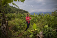 Glenda Herrera, 34, stands at the site of her home destroyed by a landslide triggered by hurricanes Eta and Iota in the village of La Reina, Honduras, Tuesday, June 29, 2021. "That night we ran down, I saw how the hill was coming down, but I never imagined that it would destroy everything." (AP Photo/Rodrigo Abd)