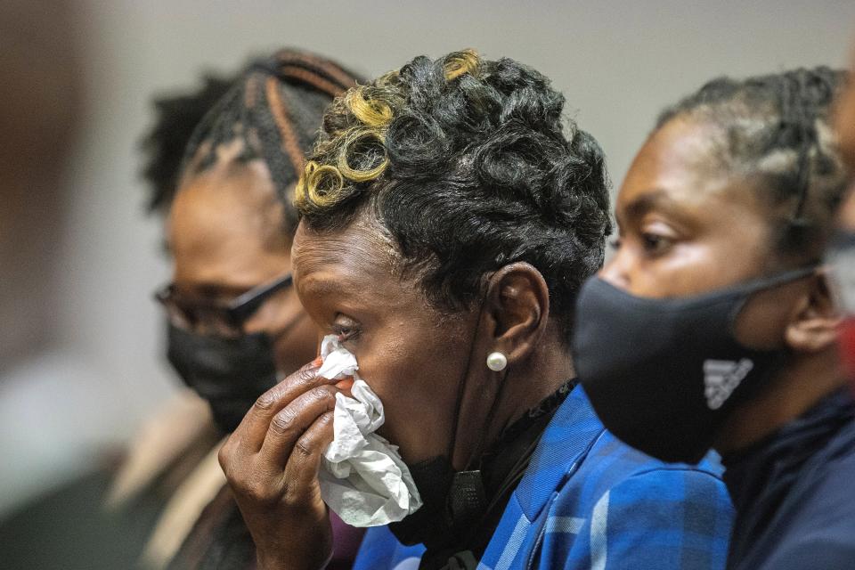 Ahmaud Arbery’s mother Wanda Cooper-Jones, center, reacts as Superior Court Judge Timothy Walmsley sentences Greg McMichael, his son, Travis McMichael, and a neighbor, William “Roddie” Bryan in the Glynn County Courthouse on Friday (AP)