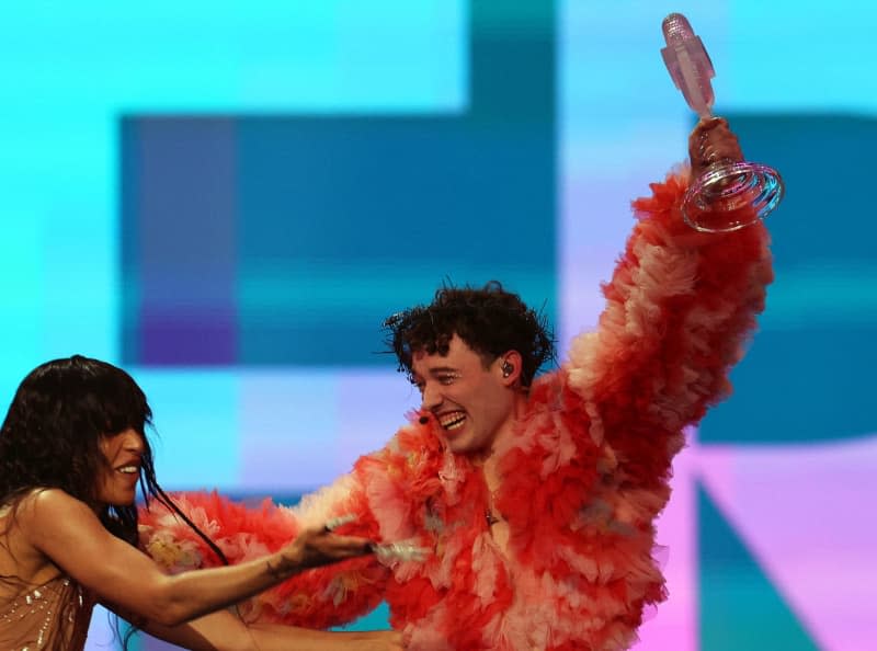 Nemo (R) from Switzerland cheers with the trophy next to Loreen, Swedish singer and winner of the Eurovision Song Contest 2023, after winning the final of the Eurovision Song Contest (ESC) 2024 in the Malmo Arena. Jens Büttner/dpa