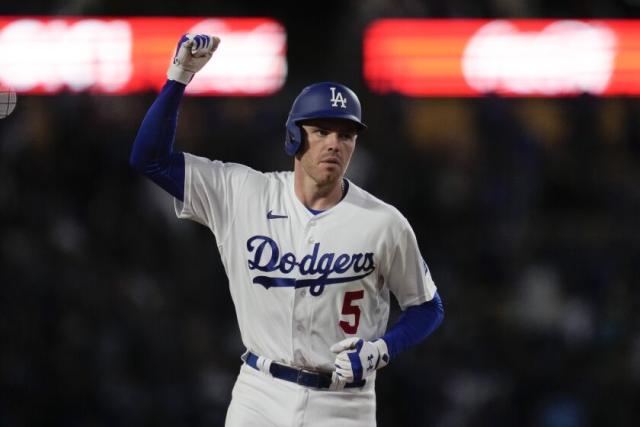 Los Angeles Dodgers' Freddie Freeman (5) follows through on a