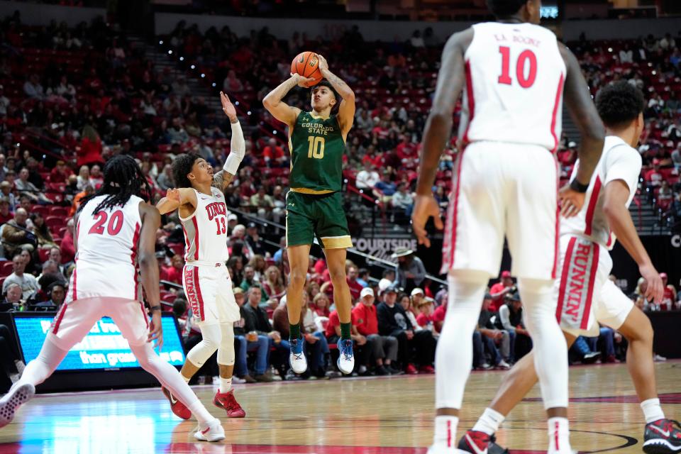 Colorado State guard Nique Clifford (10) shoots against UNLV guard Brooklyn Hicks (13) and forward Keylan Boone (20) during the second half of an NCAA college basketball game Saturday in Las Vegas.