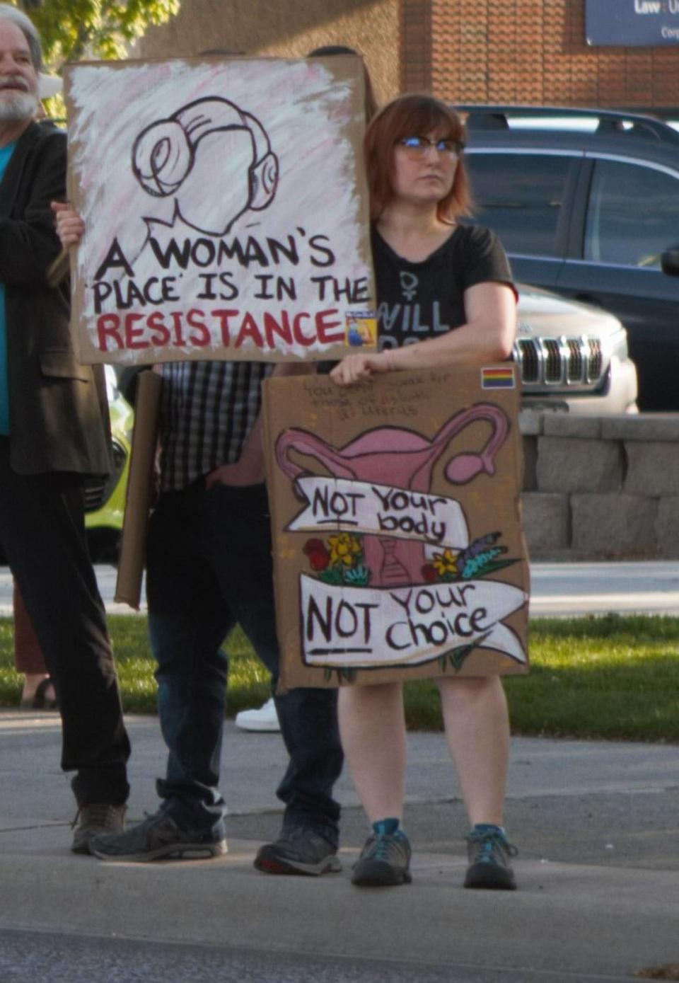 A protester supporting abortion rights at a Richland demonstration holds two signs, one reading “A woman’s place is in the resistance” which is a reference to the late Carrie Fisher and her iconic Star Wars character General Leia Organa. The other reads, “Not your body, not your choice.” Hundreds demonstrated at Jon Dam Plaza in Richland on May 4, 2022.