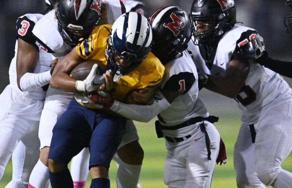 McLane’s defense swarms over Sunnyside’s Jason Dixon, center, Friday, Oct. 20, 2023 in Fresno.