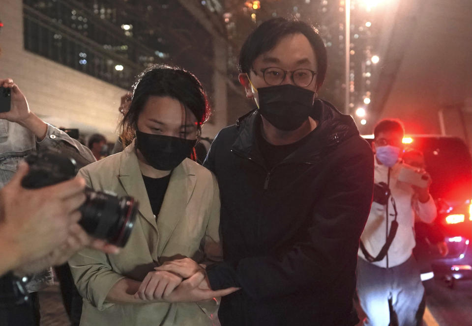 Mike Lam and his wife leave after he was released on bail at a court in Hong Kong, Friday, March 5, 2021. Four of the 47 pro-democracy activists charged with conspiracy to commit subversion, including Lam, were released on bail Friday after prosecutors dropped an appeal against the court's decision to grant them bail. (AP Photo/Kin Cheung)