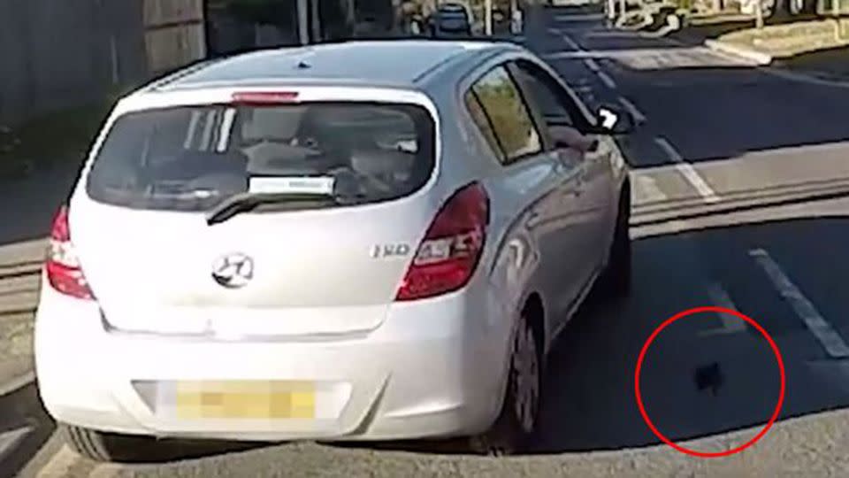 The young driver would come to regret cutting off the motorcyclist as his wallet flew off his roof. Source: YouTube