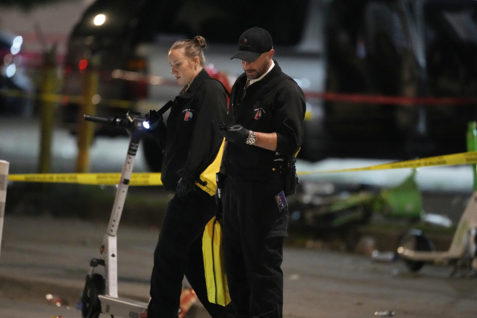 Denver Police Department investigators work the scene of a mass shooting early Tuesday, June 13, 2023, in Denver. Police say several people were wounded in an area where basketball fans had been celebrating the Denver Nuggets first NBA title win. A man who is a suspect was one of the people shot and was taken into custody. (AP Photo/David Zalubowski)