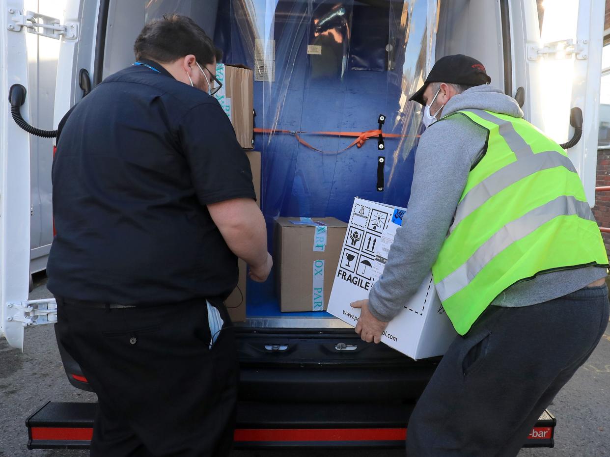 A pharmacy technician from Croydon Health Services takes delivery at Croydon University Hospital in Croydon of the first batch of Covid-19 vaccinations to be delivered to the area (PA)