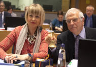 European Union foreign policy chief Josep Borrell, right, rings a bell to signify the start of a meeting of EU foreign ministers at the Europa building in Brussels, Monday, Dec. 9, 2019. European Union foreign ministers are debating how to respond to a controversial deal between Turkey and Libya that could give Ankara access to a contested economic zone across the Mediterranean Sea. (AP Photo/Virginia Mayo)