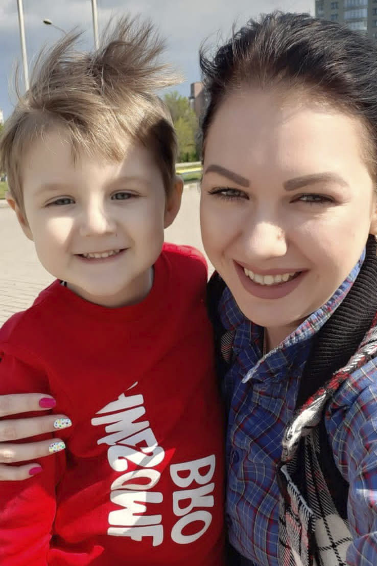 This pre-war photo provided by the family shows 5-year-old Artem Erashov, with his mother, Lydya. The boy and his 7-year-old cousin, Angelina, were killed during Russian shelling on March 9, 2022. The families of the young cousins returned to occupied Mariupol to rebury their children in the Staryi Krym cemetery, now the site of thousands of new graves since the Russian invasion began Feb. 24. (Family photo via AP)